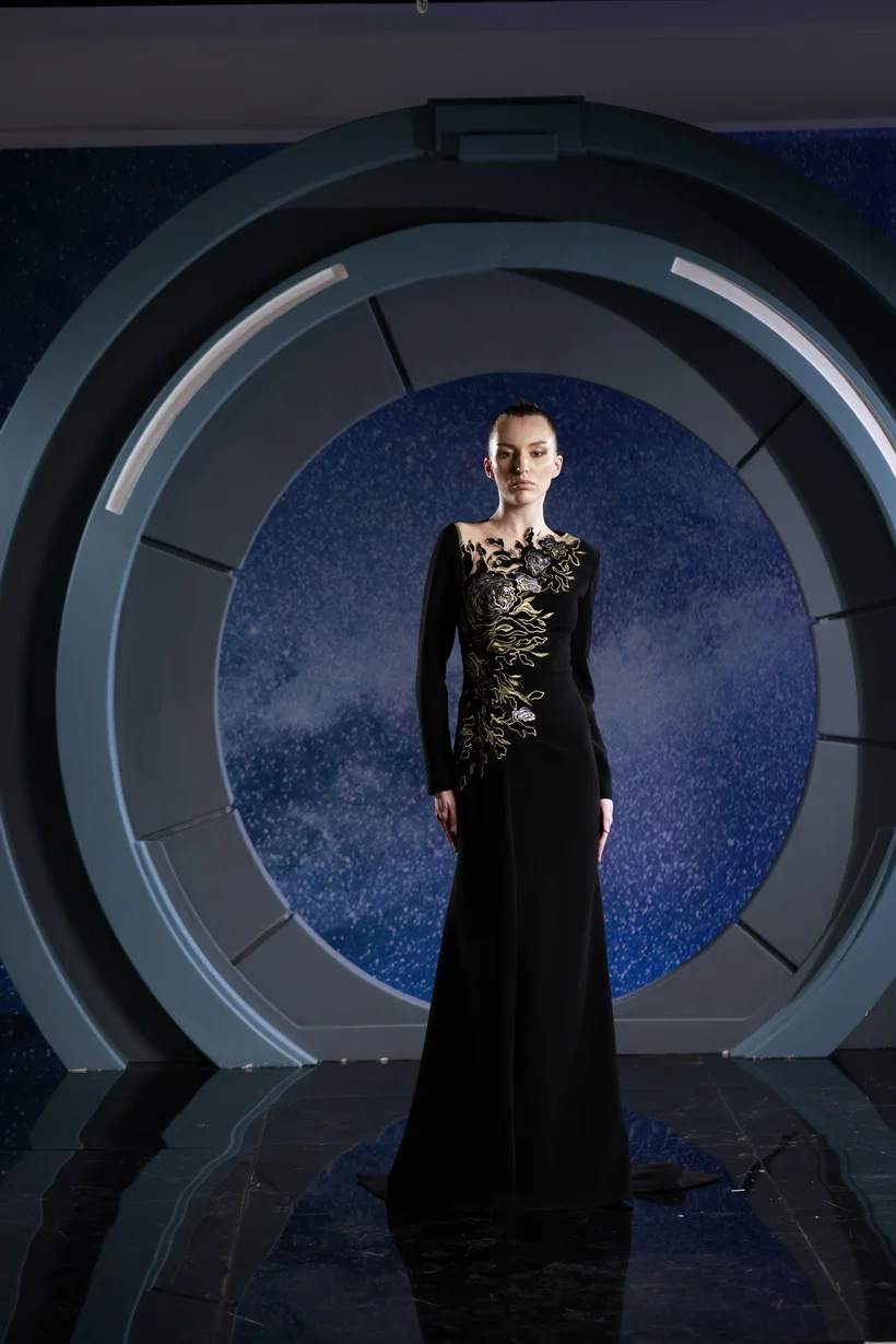 FW 111 - Black crepe marocaine dress, elevated by a single-sided  adornment of opulent gold and black lace.      Black US 01